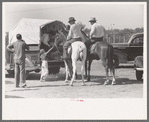 West Texans on their cow ponies buying soda pop at polo match, Abilene, Texas