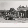 Migrant's car stopped along the road, with part of migrant family in rear seat of truck, under a tree to await the rain's passing, near Muskogee, Oklahoma