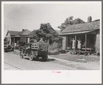 Migrant's car stopped along the road, with part of migrant family in rear seat of truck, under a tree to await the rain's passing, near Muskogee, Oklahoma