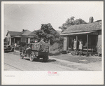 Migrant's car stopped along the road, with part of migrant family in rear seat of truck, under a tree to await the rain's passing, near Muskogee, Oklahoma