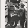 Tying lantern onto the back of improvised truck which will travel to California near Muskogee, Oklahoma