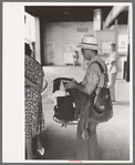 Postman with equipment waiting to board. Streetcar terminal, Oklahoma City, Oklahoma