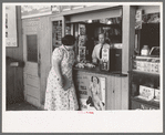 Tobacco stand keeper talking with woman. Streetcar terminal, Oklahoma City, Oklahoma