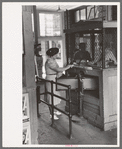 Woman buying ticket at gate. Streetcar terminal, Oklahoma City, Oklahoma