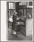 Woman buying ticket at gate. Streetcar terminal, Oklahoma City, Oklahoma