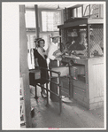 Young couple buying tickets at entrance turnstile. Streetcar terminal, Oklahoma City, Oklahoma