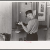 Motorman with lunch basket making out reports. Streetcar terminal, Oklahoma City, Oklahoma