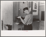 Motorman with lunch basket making out reports. Streetcar terminal, Oklahoma City, Oklahoma