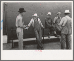 Men leaning and sitting on rail, Muskogee, Oklahoma