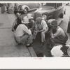 Group of men talking in street of Muskogee, Oklahoma