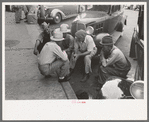 Group of men talking in street of Muskogee, Oklahoma