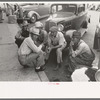 Group of men talking in street of Muskogee, Oklahoma