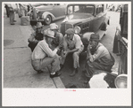 Group of men talking in street of Muskogee, Oklahoma