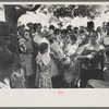 Group of people assembled under tree to listen to revival rally on Saturday afternoon, Tahlequah, Oklahoma