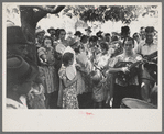 Group of people assembled under tree to listen to revival rally on Saturday afternoon, Tahlequah, Oklahoma