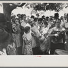 Group of people assembled under tree to listen to revival rally on Saturday afternoon, Tahlequah, Oklahoma