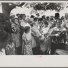 Group of people assembled under tree to listen to revival rally on Saturday afternoon, Tahlequah, Oklahoma