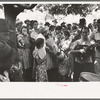 Group of people assembled under tree to listen to revival rally on Saturday afternoon, Tahlequah, Oklahoma