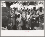 Group of people assembled under tree to listen to revival rally on Saturday afternoon, Tahlequah, Oklahoma