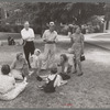 Group of people sitting in square in front of courthouse, Tahlequah, Oklahoma