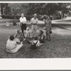 Group of people sitting in square in front of courthouse, Tahlequah, Oklahoma