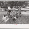 Group of people sitting in square in front of courthouse, Tahlequah, Oklahoma