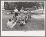 Group of people sitting in square in front of courthouse, Tahlequah, Oklahoma