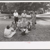 Group of people sitting in square in front of courthouse, Tahlequah, Oklahoma