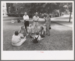 Group of people sitting in square in front of courthouse, Tahlequah, Oklahoma