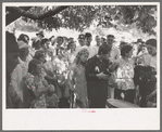 Revivalist surrounded by speculators at rally under trees in square, Saturday afternoon, Tahlequah, Oklahoma