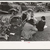 Farm people eating watermelon on lawn in front of courthouse, Tahlequah, Oklahoma