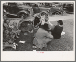 Farm people eating watermelon on lawn in front of courthouse, Tahlequah, Oklahoma