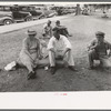 Farm people sitting on automobile cushion in square, Tahlequah, Oklahoma