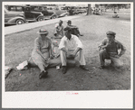 Farm people sitting on automobile cushion in square, Tahlequah, Oklahoma