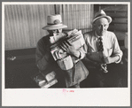 Postman loaded with mail waiting for streetcar. Streetcar terminal, Oklahoma City, Oklahoma