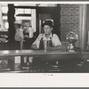 Man drinking malted milk at stand in streetcar terminal, Oklahoma City, Oklahoma