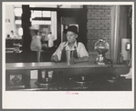 Man drinking malted milk at stand in streetcar terminal, Oklahoma City, Oklahoma