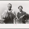 William Rall, FSA (Farm Security Administration) client standing amidst kaffir corn on his farm in Sheridan County, Kansas