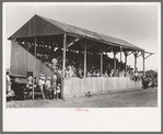 The grandstand at former county fairgrounds filled with spectators at the 4-H Club fair, Cimarron, Kansas