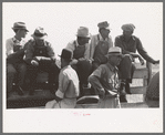 Farmers sitting on the fence at 4-H Club fair, Cimarron, Kansas