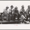 Farmers sitting on the fence at 4-H Club fair, Cimarron, Kansas