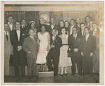 Attendees at a cultural program honoring Cuban declamdora Eusebia Cosme (fourth from left, front row), with Alberto Socarras (standing on Cosme's left), and other guests