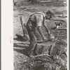 Son of Mr. Germeroth, FSA client, getting ready to cut off a chicken head. Sheridan County, Kansas