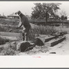 Wrecking foundation of old building in Forgan, Oklahoma, which is a dust town