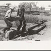 Wrecking foundation of old building in Forgan, Oklahoma, which is a dust town