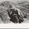 Roustabout in the oil fields drinking water from the top of a five-gallon can. Seminole oil field, Oklahoma