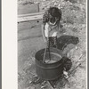 Spanish-American FSA client stirring kettle of soap, Taos County, New Mexico