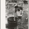 Adding lye to grease in soap making, Spanish-American FSA client, Taos County, New Mexico