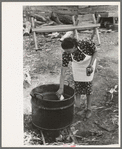 Adding lye to grease in soap making, Spanish-American FSA client, Taos County, New Mexico