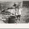 Spanish-American client adding water to soap in kettle, Taos County, New Mexico